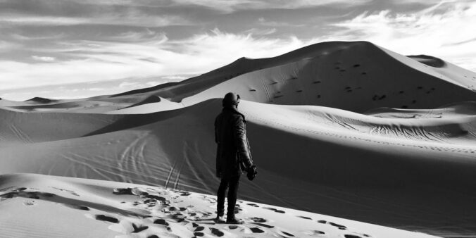 person standing on desert