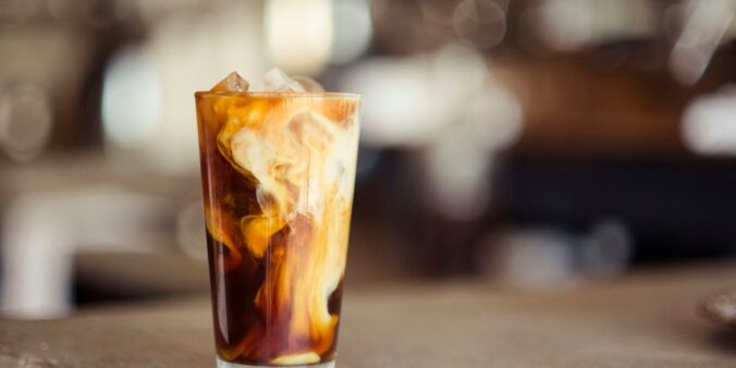 glass cup filled with ice latte on tabletop