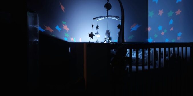 baby's black wooden crib with LED crib mobile