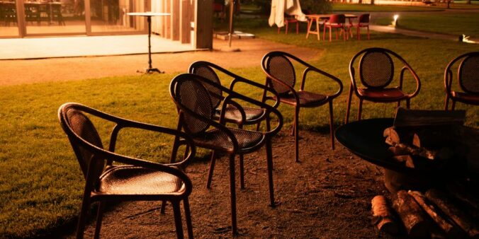 a row of chairs sitting next to a fire pit