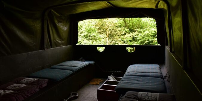 a couple of beds sitting inside of a tent